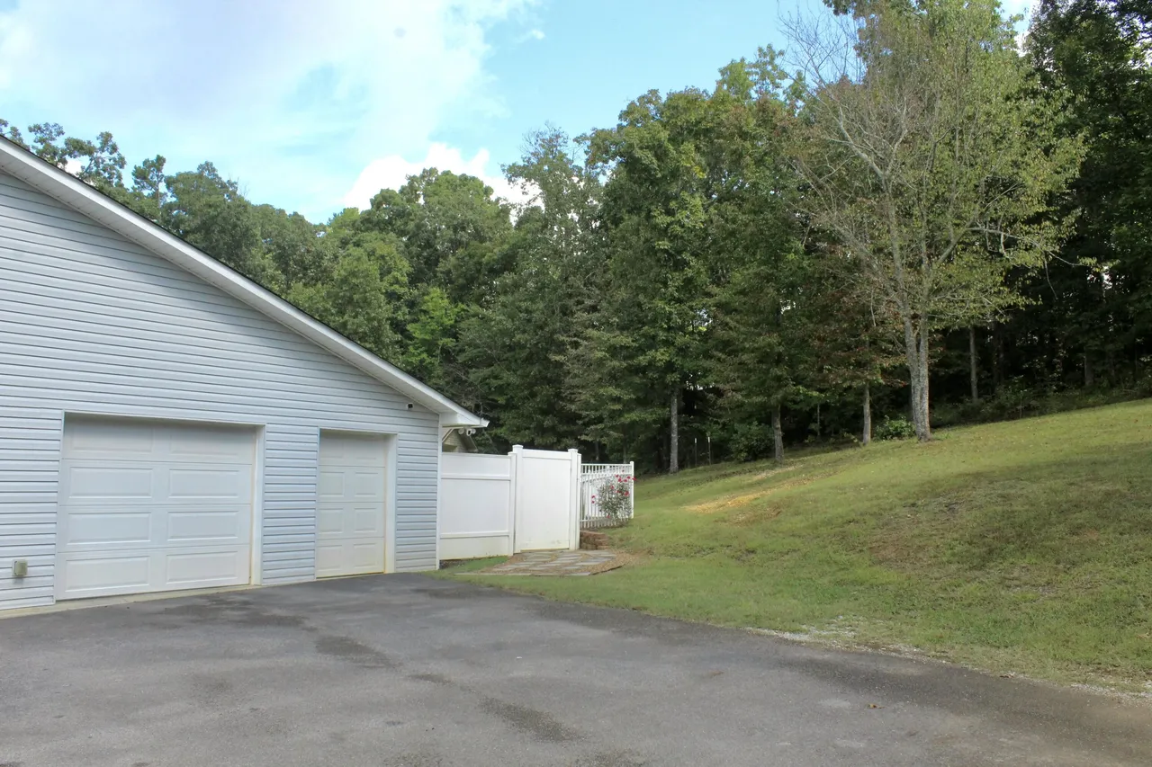 Oversized garage beside wooded property